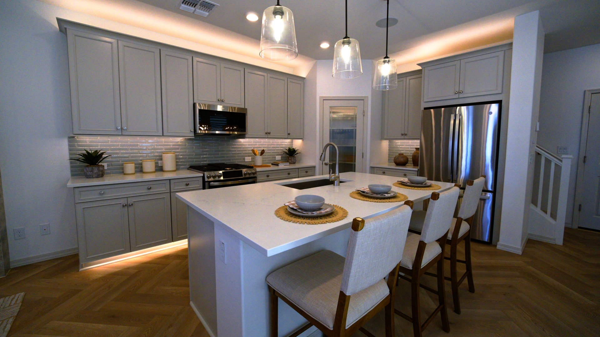 Bright staged kitchen with large island and pendant lighting